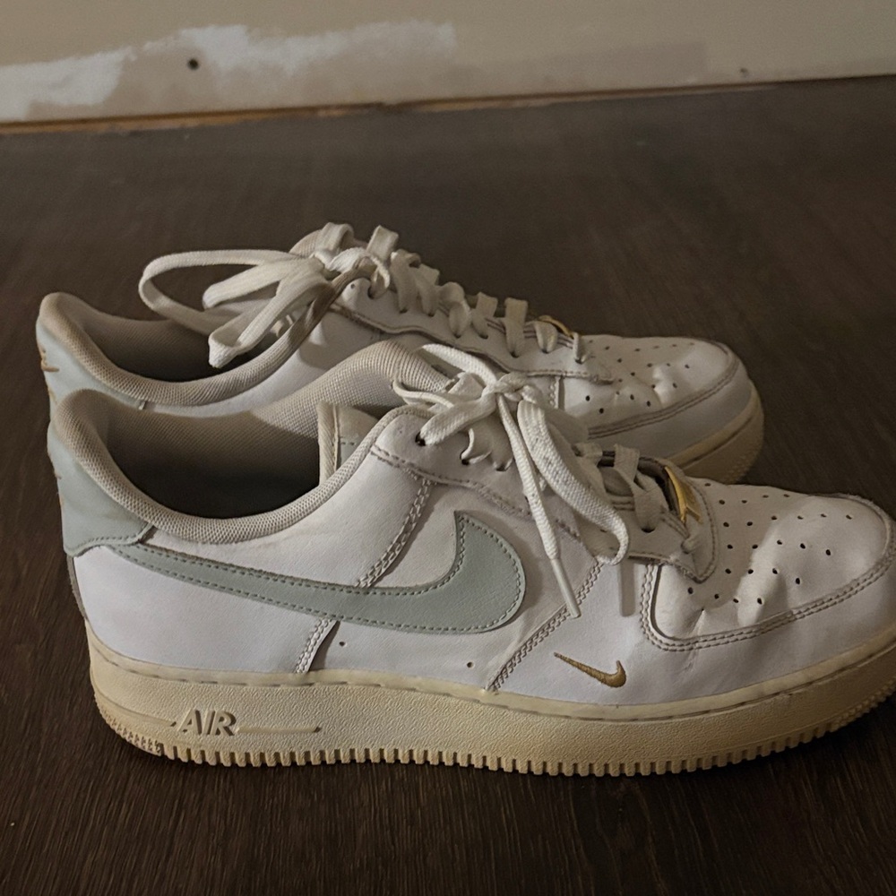 White and Gray Sneakers with Gold Accents Nike